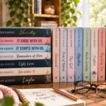 Stack of Colleen Hoover books in a bright cozy reading setting with coffee, glasses, and natural light